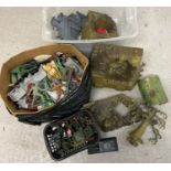 A large quantity of assorted vintage play set pieces, toy soldiers, tanks, weapons and accessories.