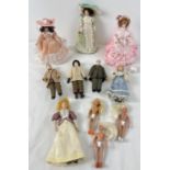 A small collection of modern doll House dolls with ceramic heads and limbs, in traditional Victorian