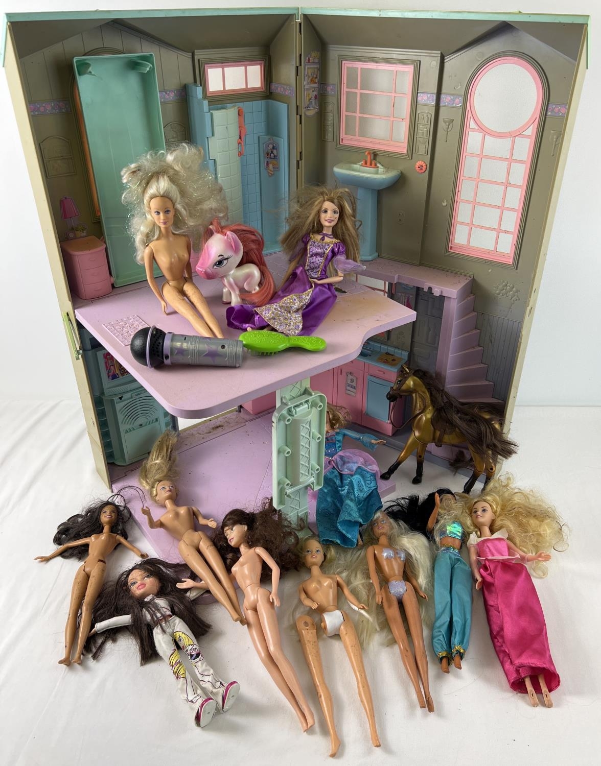 A box of assorted Barbie, Disney Princess & Bratz dolls together with a Barbie folding townhouse.