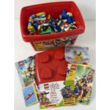 A red Lego brick tub #4497 of assorted Lego pieces and manuals. Total weight 3.15Kg.