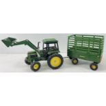 An Ertl 1/16 scale John Deere tractor and trailer. #2755 tractor with 3 position front loader