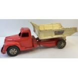 A vintage 1950's tinplate Buddy L Hydraulic Dump Truck, by Mettoy. Painted red cabin and base with