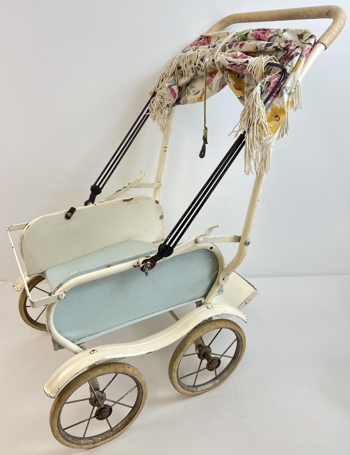 A vintage Marmet dolls pushchair with rubber tyres and grip handle. Original canopy frame has had