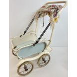 A vintage Marmet dolls pushchair with rubber tyres and grip handle. Original canopy frame has had