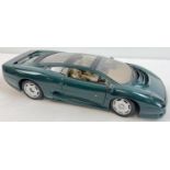 A Maisto Jaguar XJ220 scale 1/12 diecast model car in green. With opening doors and bonnet.