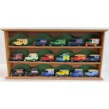 A wooden wall hanging display shelf unit for model cars, together with 17 advertising diecast