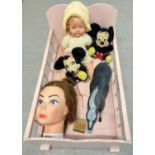 A vintage wooden dolls cot, painted pink, together with a 21" dressed doll and other misc toys.
