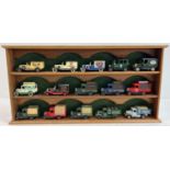 A wooden wall hanging display shelf unit for model cars together with 15 advertising diecast