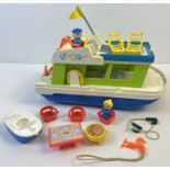 A vintage Fisher Price Happy House Boat with figures and accessories. Some age related sun fading to