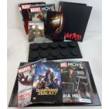 A box containing Number 1 to 31 Marvel movie magazines by Eaglemoss in two binders with plinth stand