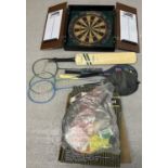 A collection of assorted outdoor toys and sports equipment. To include dart board in wooden wall