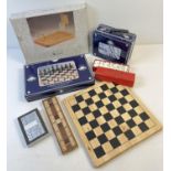 A box of assorted boxed games to include dominoes, chess & draughts and desktop basketball.