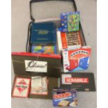 A suitcase of assorted vintage and modern board games and puzzles. To include early Monopoly,