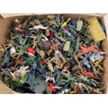 A large quantity of assorted vintage plastic Cowboys & Indians and toy soldiers, mostly unmarked,