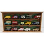 A wooden wall hanging display shelf unit for model cars, together with 15 advertising diecast
