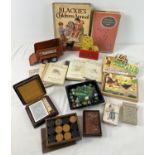 A box of assorted vintage toys, books and games. To include marbles, playing cards, wooden draughts,