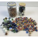 A collection of assorted vintage glass, clay and stone marbles. In varying sizes & colours.