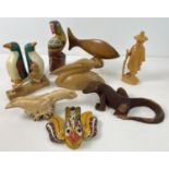 A collection of carved wooden animals and figures, some painted. To include parrot, pelican,