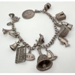 A vintage white metal curb chain bracelet with 15 silver and white metal charms. No clasp to