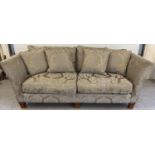 A modern 3 seater sofa and matching footstool in coffee coloured damask fabric with feather filled