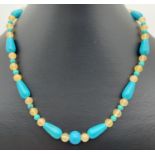 A 16" turquoise and jade beaded necklace of teardrop shaped and spherical beads. With silver tone