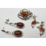 3 items of silver and white metal amber set jewellery. An Art Nouveau style brooch with floral