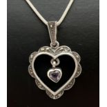 A silver marcasite set open heart pendant with central heart shaped amethyst drop. On an 18" snake