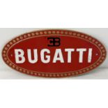 An oval shaped Bugatti cast iron wall plaque, painted red, black, white & gold. Approx. 17cm x 35cm.