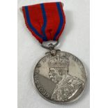 A George V Metropolitan Police Coronation 1911 medal, named to P.C. G Greenfield. On red and blue