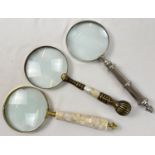 3 large magnifying glasses to include brass handled set with pearl, and silver tone with turned