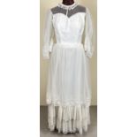 A vintage 1970's lace layered dress with angel sleeves and high neck.