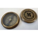 A reproduction brass cased German WWII style N.S.D.A.P compass with screw lid. Underside marked with