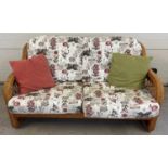 A modern light wood wicker 5 piece conservatory set with floral upholstered cushions. Comprising