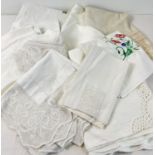 A quantity of vintage and antique table cloths and table linen. To include lace trimmed and