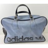 A vintage blue and black classic design Adidas holdall. Adidas name to front with 2 carry handles