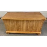 A modern pine blanket/toy chest with lift up lid and bun feet. Approx. 45cm tall x 86cm long.