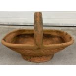 A large terracotta garden planter in the shape of a flower basket. Approx. 40cm tall x 60cm long.