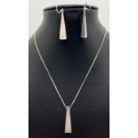 A modern triangular design pendant necklace with a pair of matching drop earrings. Silver marks to