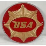 A circular shaped BSA cast iron wall plaque, painted red & gold with a silver rim. Approx. 24.5cm