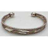 A decorative 3 band cuff bangle with twist design to middle band. Silver marks to one end. Total