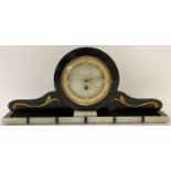 An Art Deco black slate and onyx mantle clock with gold scroll applique detail. Onyx face with