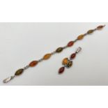 A silver bracelet and matching drop pendant set with green, honey and cognac marquise cut amber