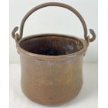 An antique copper and brass cooking pot with riveted iron swing handle. Approx. 14cm tall (excluding