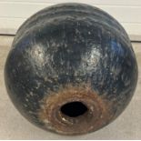 A large vintage cast iron marine bouy, painted black, with hole through the centre. Approx. 53cm