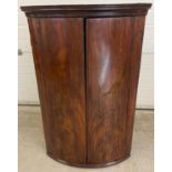 A Georgian mahogany curve fronted corner cupboard with 3 interior fixed shelves. Approx. 110cm