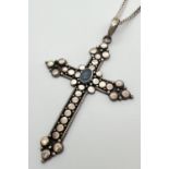A large modern design cross pendant with circle decoration, set with an oval opal stone on a 20"