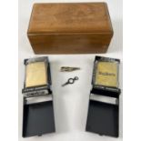 2 cased Zippo Lighters together with a small wooden box, watch key & car detail tie clip. A plain