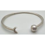 A silver star and moon stone set bangle by Pandora. Pandora silver marks to inside of bangle and