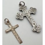 2 vintage silver cross pendants. A small crucifix together with a Victorian engraved cross with
