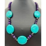 An 18" costume jewellery necklace of Chinese turquoise and purple jasper beads. With silver tone S